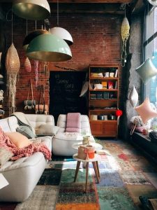 Apartment with brick wall, white sofa, large window and a big shelf