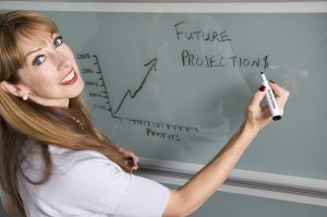 Female professor showing a graph of future projections - important step of a freshman moving guide.