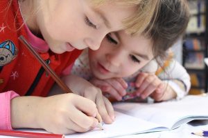 Little girls studying together.