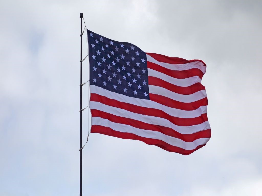 The American flag on a flagpole.