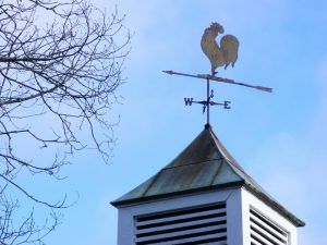 A weather vane on the top of a farm house in Kentucky.