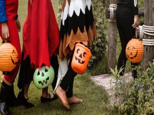 Kids in costumes trick-or-treating, instead of going to one of the top places to celebrate Halloween across the US.