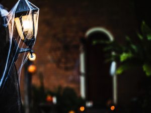 A street lamp in New Orleans, decorated with fake spider webs for Halloween.