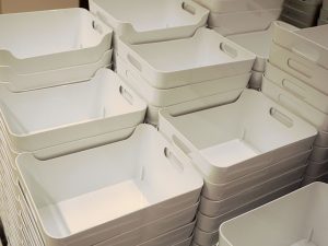 Rows of stacked white plastic bins.