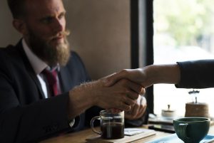 A handshake between two people. 