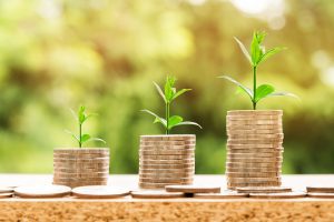 Three stacks of coins to pay for long distance moving companies Newark.