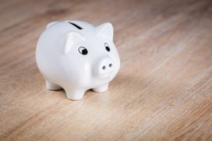 A white piggy bank to save for long distance moving companies Kaneohe.