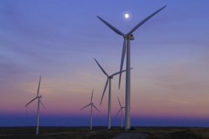 five windmills in front of ocean