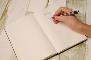 A woman making a plan, her own guide for long distance move.