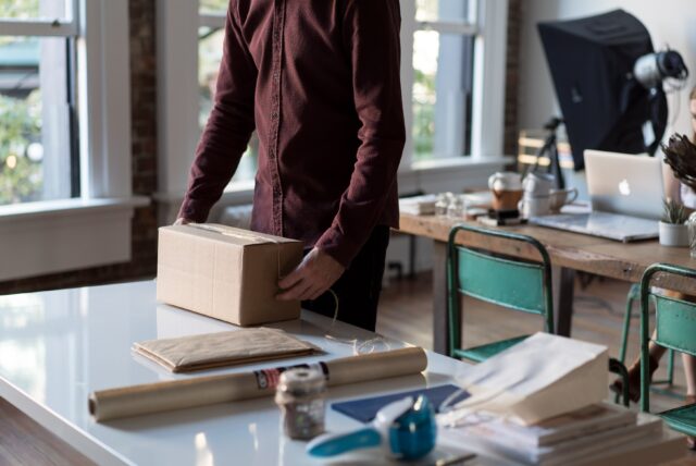 Man packing a box.