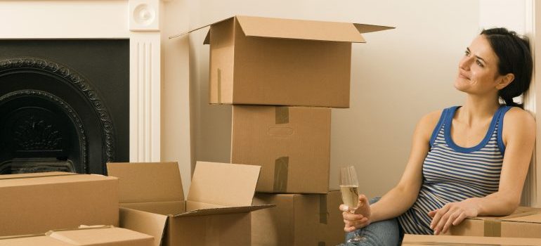 Woman drinking champagne in new home forCross Country Moving Companies Montgomery