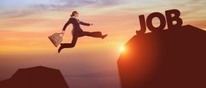 Woman jumping from lower rock to higher rock with word - Job