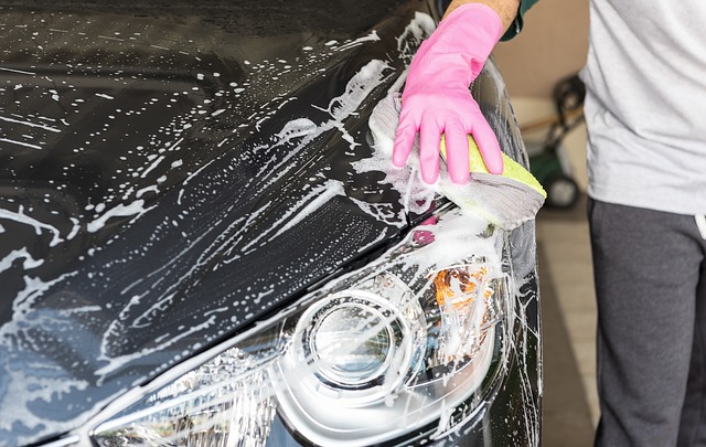 Man washing his car after reading our guide on how to prep your car for long-term storage