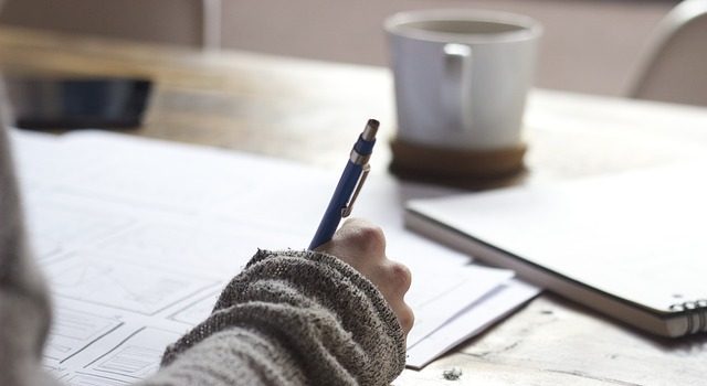 a woman doing paperwork for cross country moving companies Mobile