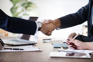 Two men in suits shaking hands