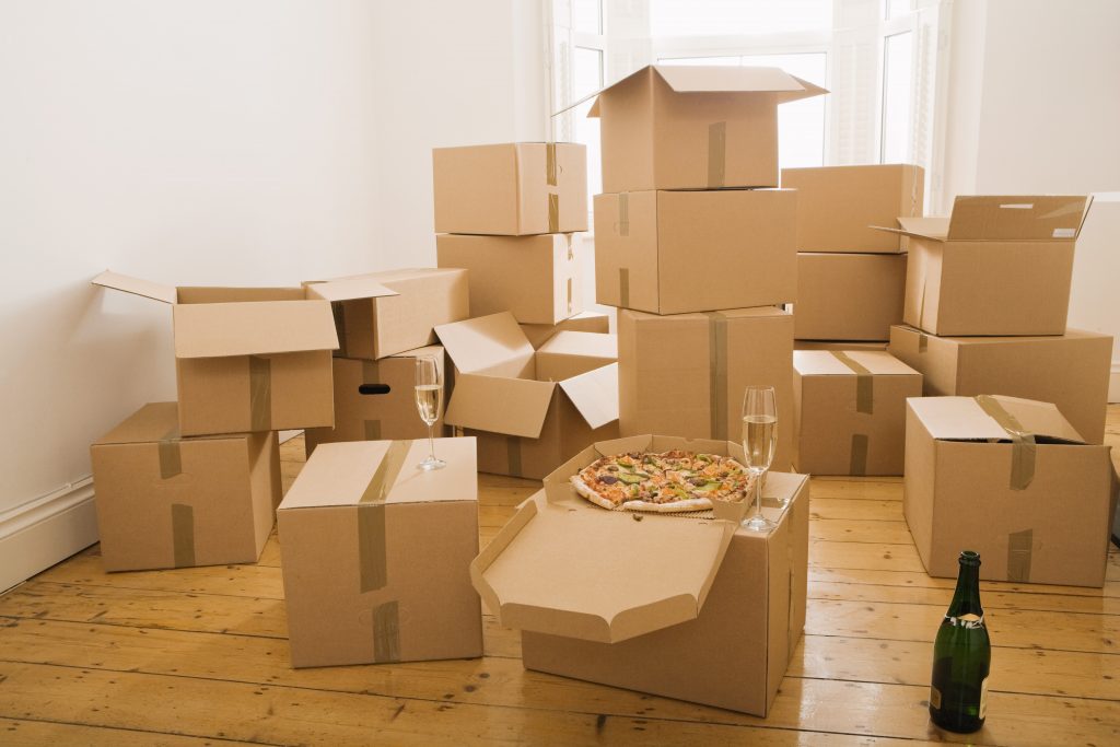 Pizza and champagne on moving boxes