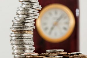 Coins and a clock in the background