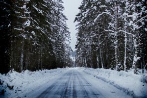 moving on holidays on a snowy forest road