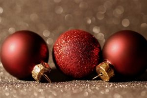 Three red baubles on a table