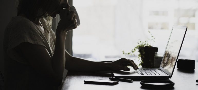 a woman researching cross country moving companies Bowling Green