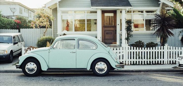 a Volkswagen beetle in front of a house