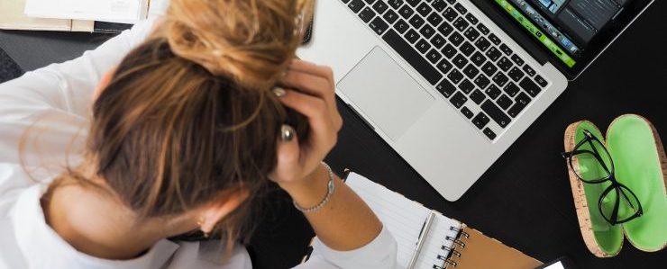 A woman holding her head because of stress