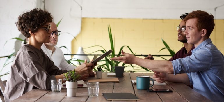 Four people sitting at a desk