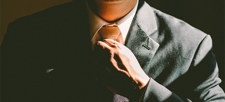 A man fixing his tie