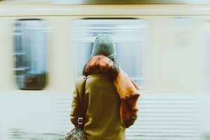 person next to a moving train