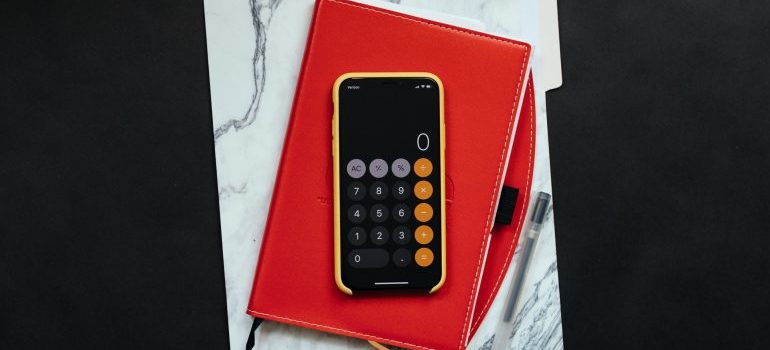 A phone on top of two notebooks