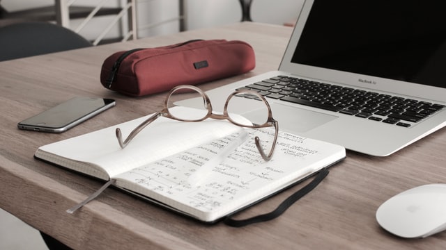 A laptop and notebook for research before moving from Alaska to Florida