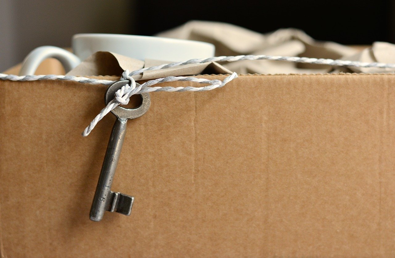 a key sticking out of a cardboard box