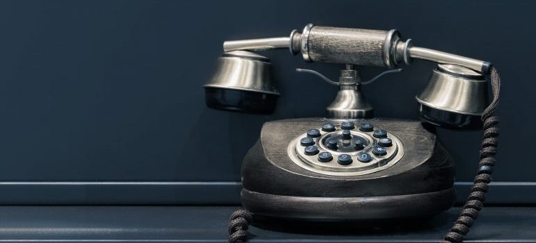 A black rotary dial phone