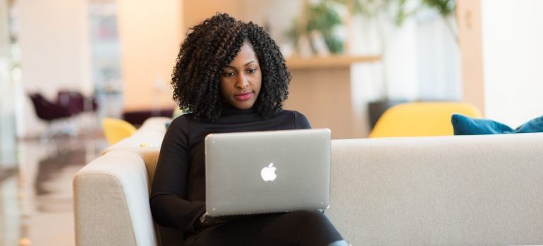 Woman reading about cross country moving companies Tulsa