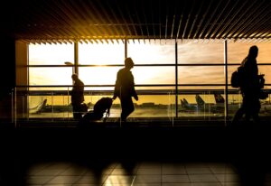 A man on an airport during a sunset, moving with the help of Cross country moving companies Broken Arrow