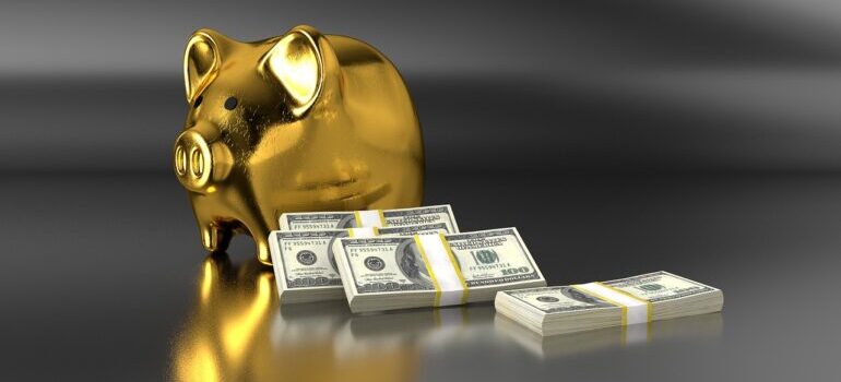 A golden piggy bank with stacks of dollars