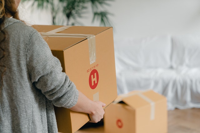 Woman carrying a cardboard box