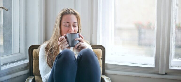 a woman relaxing holding a cup of coffee 