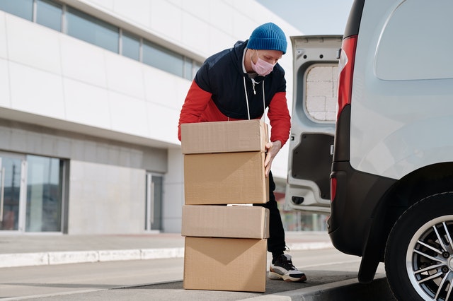 Mover putting boxes in the van