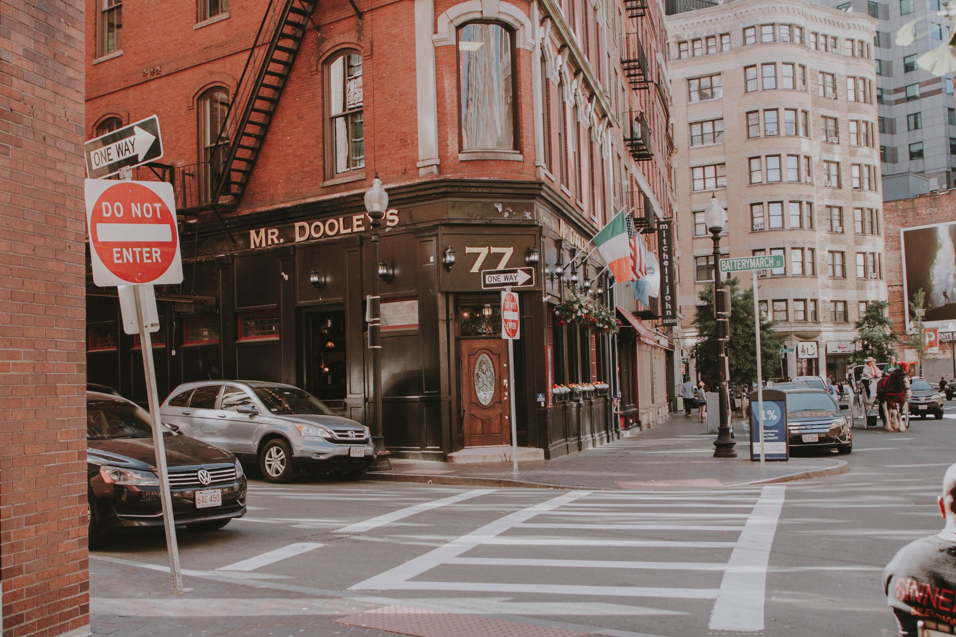 a crossroads in front of a red-brick building