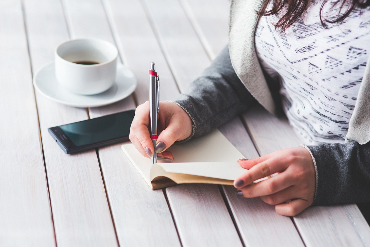 woman writing down a moving list