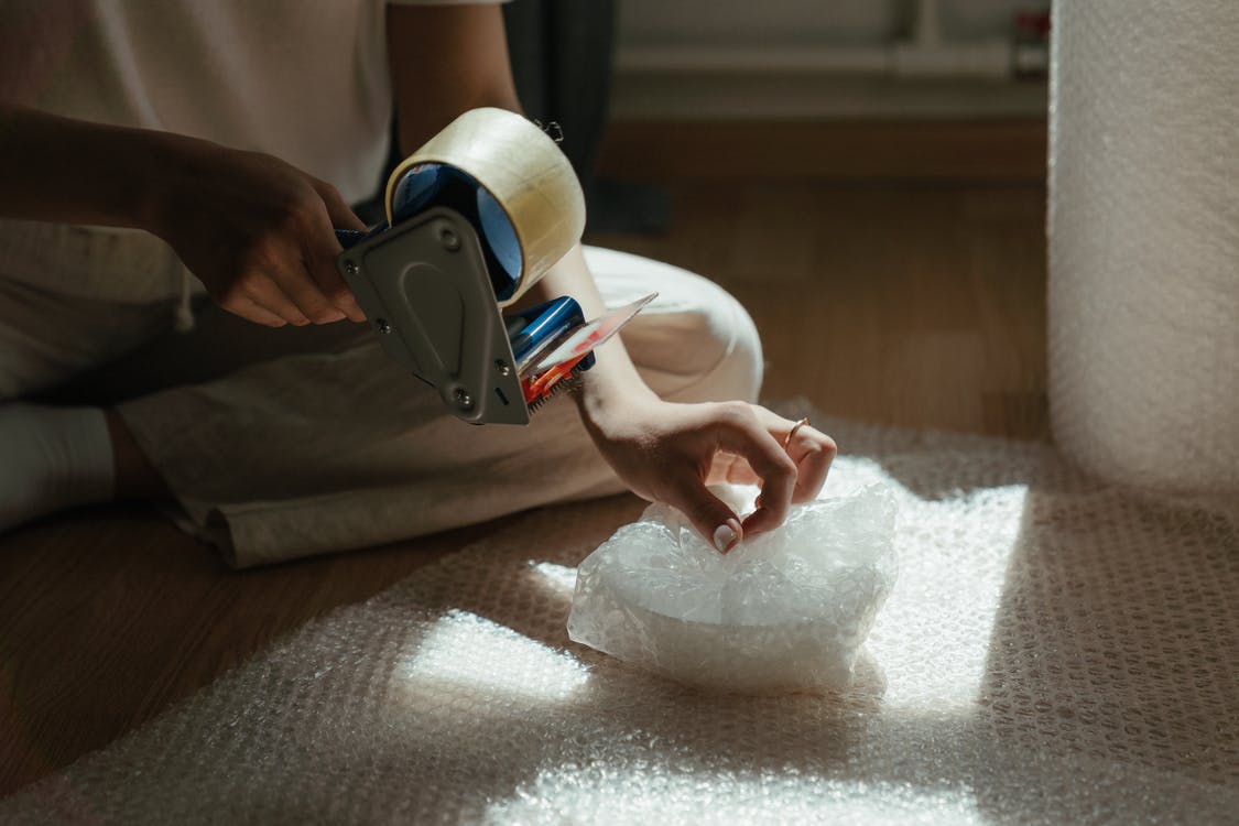 a person packing ceramic bowl