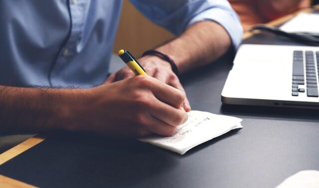 man writing down a plan