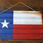 a Texas state flag hanging on a wall