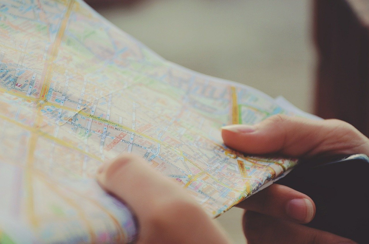 a person holding a route map in their hands