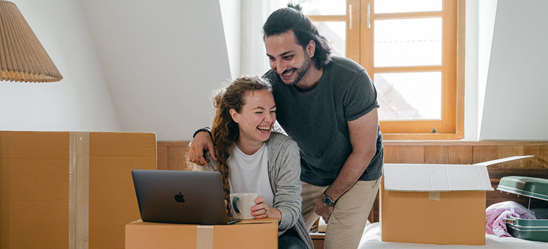 couple doing research on a laptop before moving from Colorado to Montana