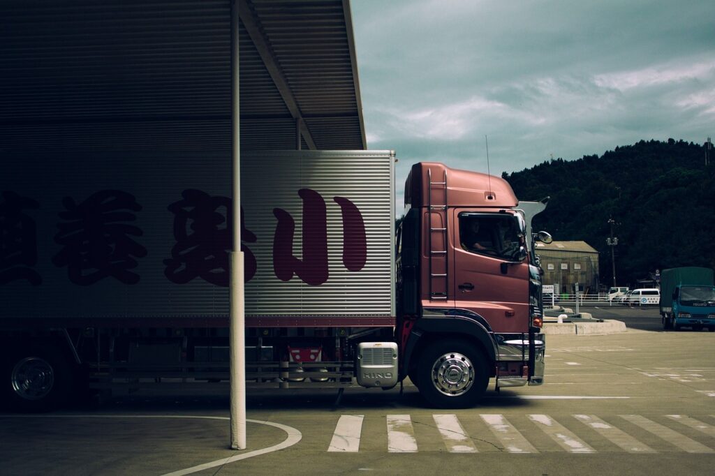 a red relocation truck underneath a bridge