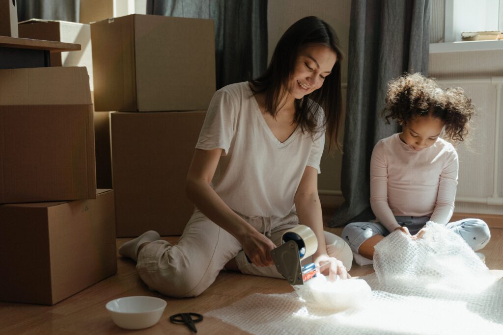 Mother and daughter packing for a move