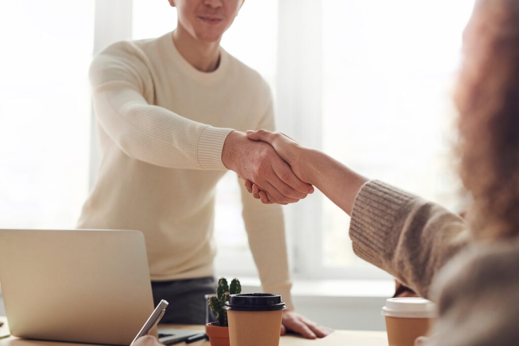 A man shaking hands with a woman