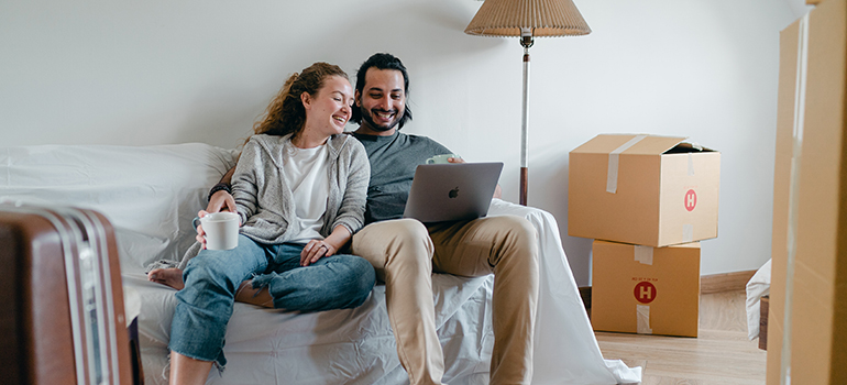 a couple checking their moving checklist before moving out of state